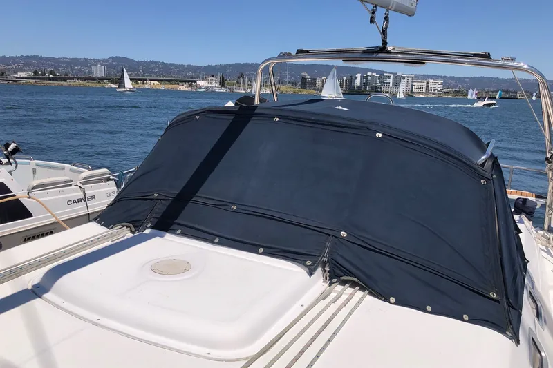 Slide: The Image of Sailboat on water, 2008 Hunter 38 model, with covered cockpit and scenic marina backdrop. - 22
