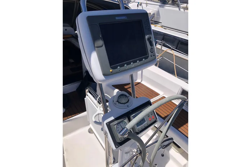 Slide: The Image of Cockpit of 2008 Hunter 38 sailboat with navigation equipment and steering wheel. - 25