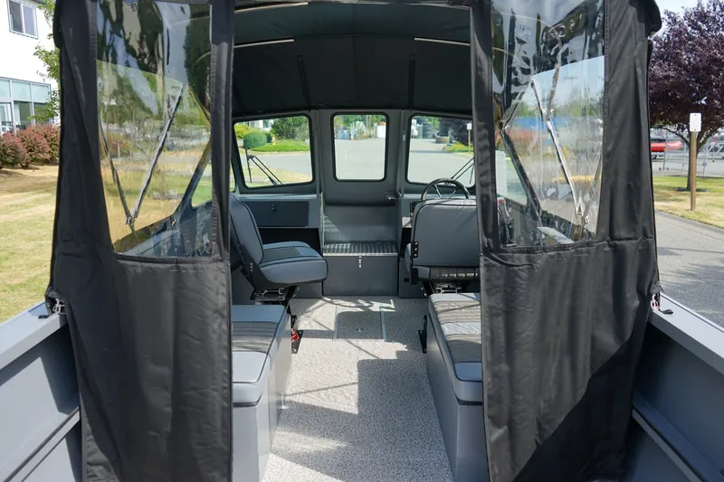 Slide: The Image of Interior view of 2026 Alumaweld Intruder Outboard 22 boat, featuring seating and steering area. - 7