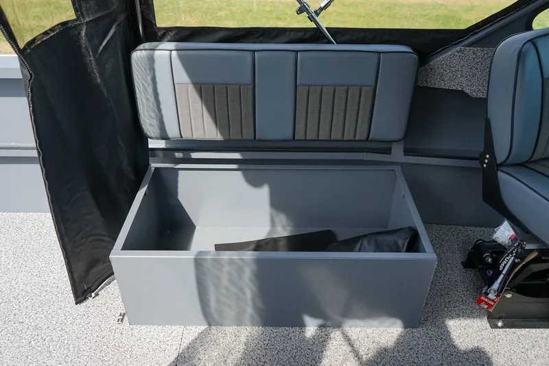 Slide: The Image of 2026 Alumaweld Intruder Outboard 22 boat interior storage compartment with cushioned seating. - 11
