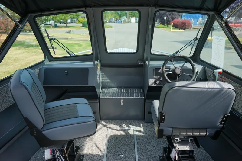 Slide: The Image of Interior of 2026 Alumaweld Intruder Outboard 22 boat, featuring dual seats and steering console. - 15