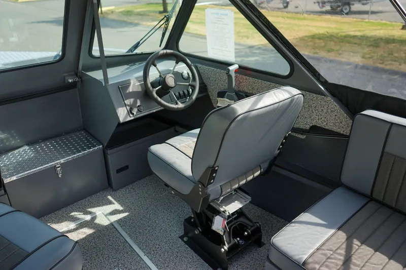 Slide: The Image of 2026 Alumaweld Intruder Outboard 22 interior with steering wheel and seating. - 12