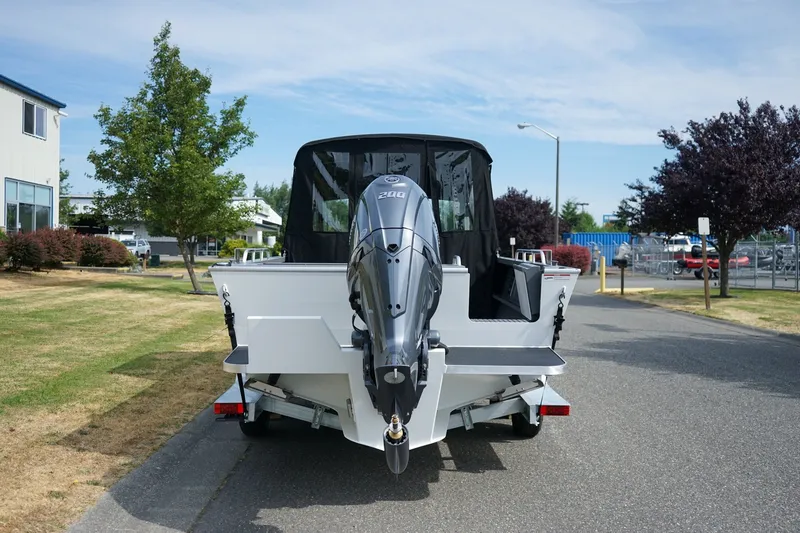 Slide: The Image of 2026 Alumaweld Intruder Outboard 22 boat with powerful engine, parked on a trailer. - 4