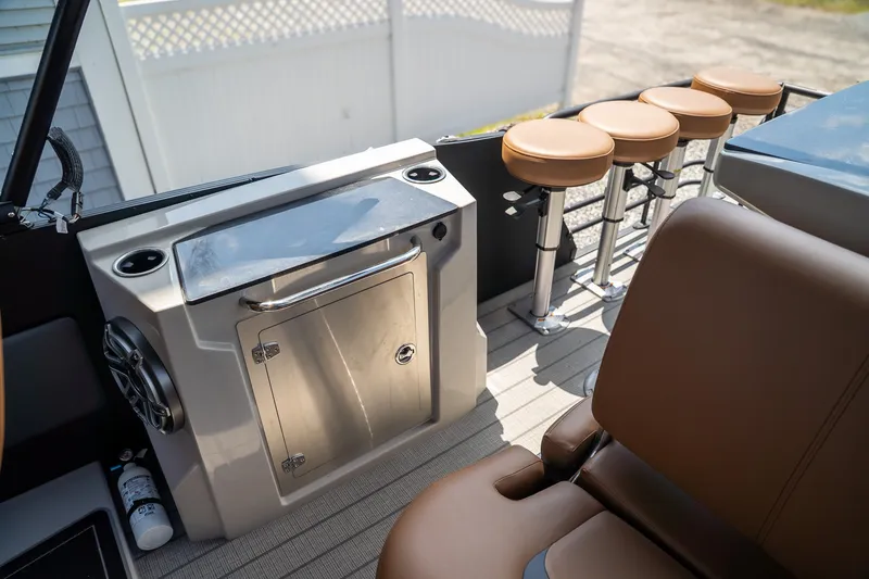 Slide: The Image of The image shows the interior of a Starcraft RX 25 DL BAR with brown seats and a stainless steel console. - 13