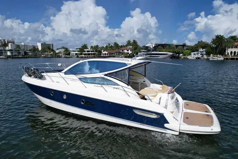 Slide: The Image of 2009 Cranchi Mediterranee 43 yacht cruising on a sunny day, with scenic waterfront backdrop. - 3