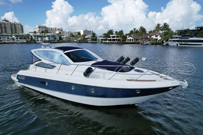 Slide: The Image of 2009 Cranchi Mediterranee 43 yacht cruising on a scenic waterfront with luxury homes. - 1