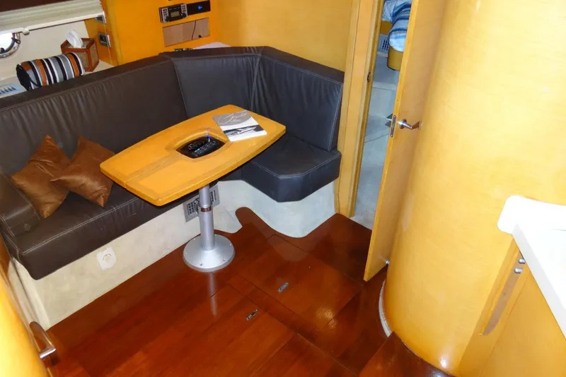 Slide: The Image of Interior of 2009 Cranchi Mediterranee 43 yacht with cozy seating and wooden table. - 16
