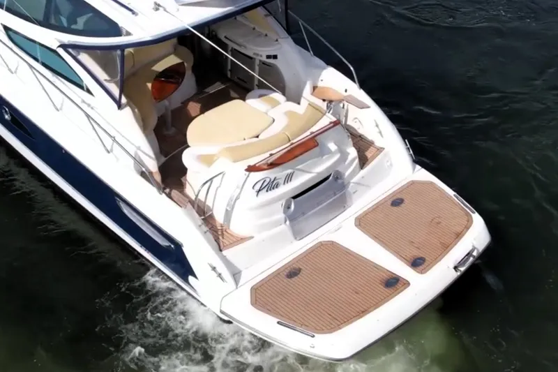 Slide: The Image of 2009 Cranchi Mediterranee 43 yacht cruising on water, featuring spacious deck and seating area. - 26
