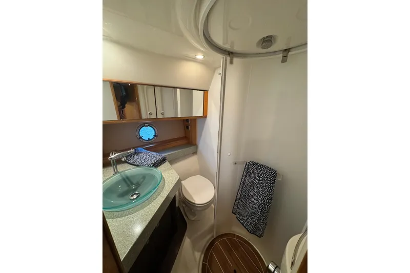 Slide: The Image of Luxurious bathroom in 2009 Cranchi Mediterranee 43 yacht with modern fixtures and porthole window. - 17