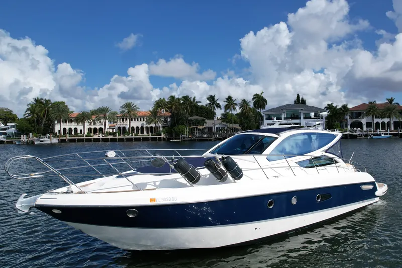 Slide: The Image of 2009 Cranchi Mediterranee 43 yacht on water, with luxury waterfront homes in the background. - 34
