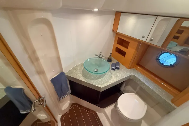 Slide: The Image of Luxurious bathroom in 2009 Cranchi Mediterranee 43 yacht with modern fixtures and porthole window. - 18