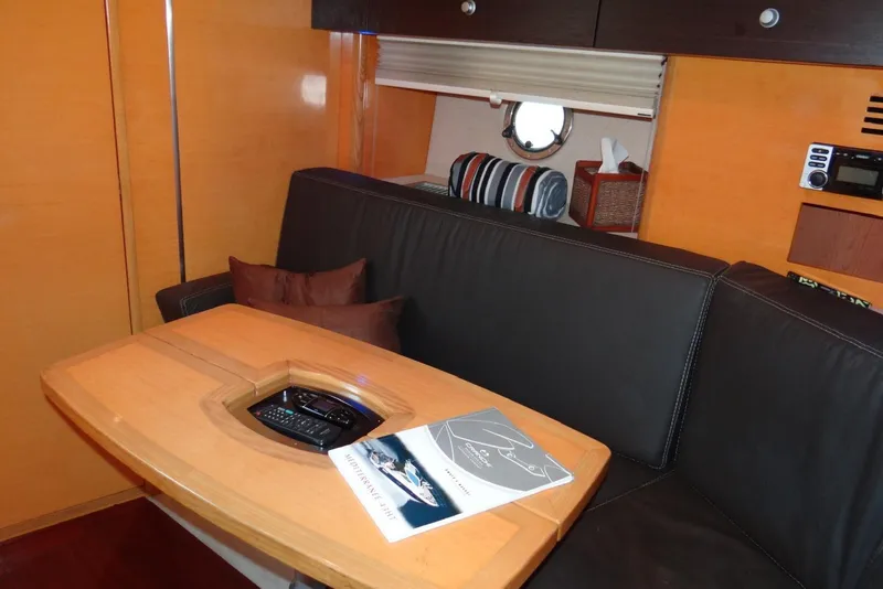 Slide: The Image of Interior of 2009 Cranchi Mediterranee 43 yacht with cozy seating and wooden table. - 15