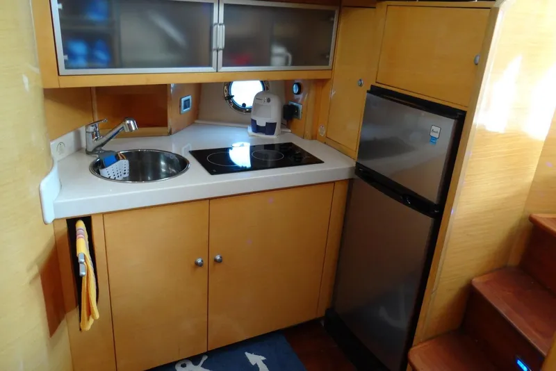 Slide: The Image of Compact kitchen area in 2009 Cranchi Mediterranee 43 yacht with sink, stove, and fridge. - 13