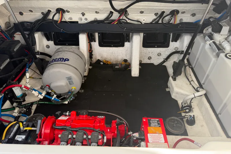 Slide: The Image of Engine compartment of a 2021 Monterey 385SE Super Express boat, showcasing wiring and components. - 53