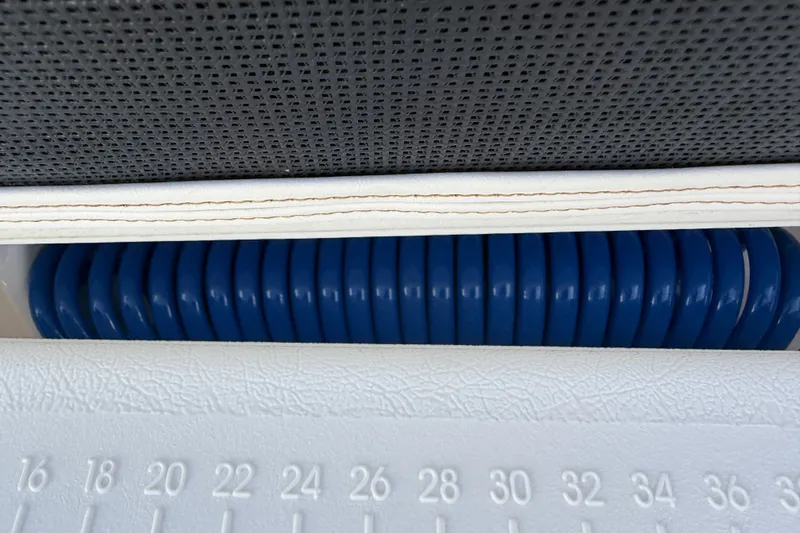 Slide: The Image of Close-up of a 2021 Monterey 385SE Super Express boat interior with blue coiled hose. - 43