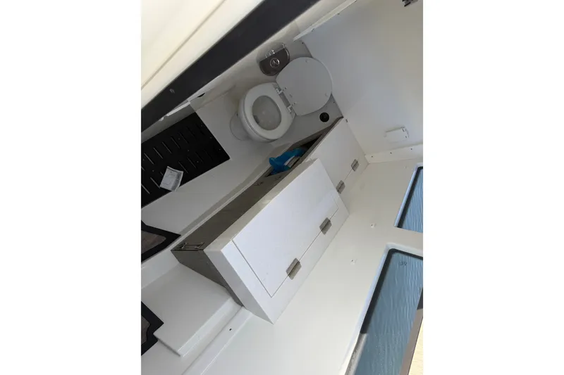 Slide: The Image of Interior of 2021 Monterey 385SE Super Express boat bathroom with toilet and storage. - 36