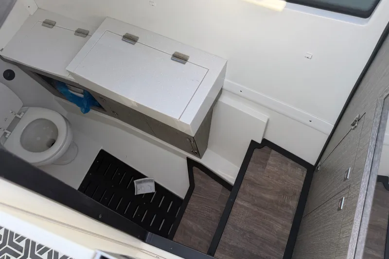 Slide: The Image of Interior of 2021 Monterey 385SE Super Express boat bathroom with toilet and storage. - 35