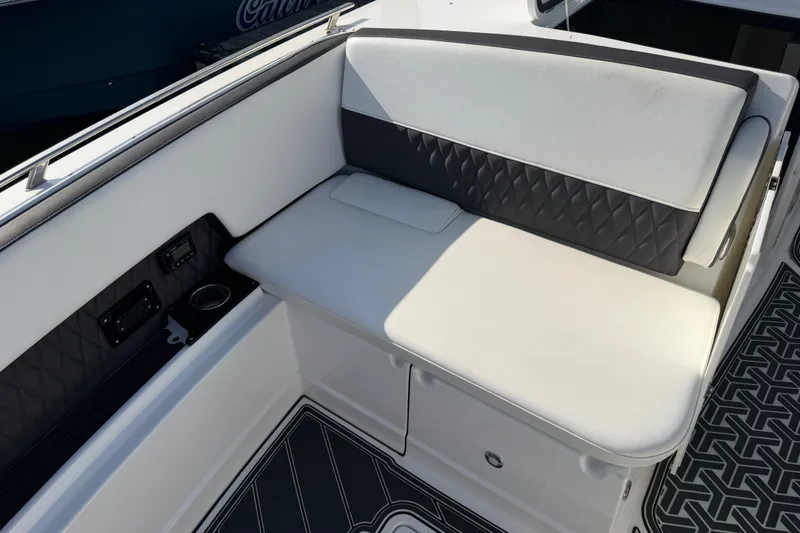 Slide: The Image of 2021 Monterey 385SE Super Express boat interior with cushioned seating and cup holder. - 46