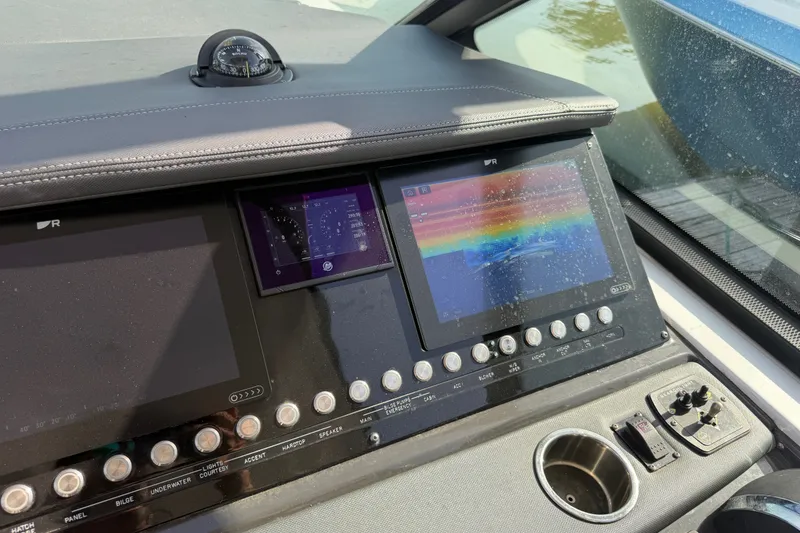 Slide: The Image of Dashboard of a 2021 Monterey 385SE Super Express boat with navigation screens and controls. - 54