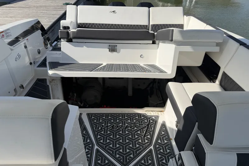 Slide: The Image of 2021 Monterey 385SE Super Express boat interior with stylish seating and patterned flooring. - 61