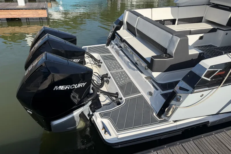 Slide: The Image of 2021 Monterey 385SE Super Express boat with triple Mercury outboard engines docked. - 65