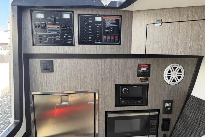 Slide: The Image of Control panel and appliances inside a 2021 Monterey 385SE Super Express boat cabin. - 37