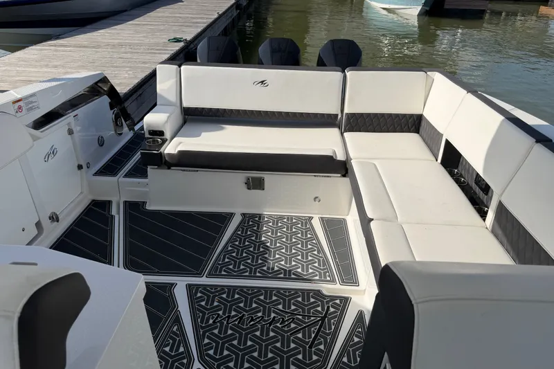 Slide: The Image of Luxurious seating area on a 2021 Monterey 385SE Super Express boat docked by the water. - 33