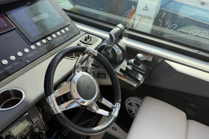 Slide: The Image of Steering console of 2021 Monterey 385SE Super Express boat with modern controls and displays. - 32