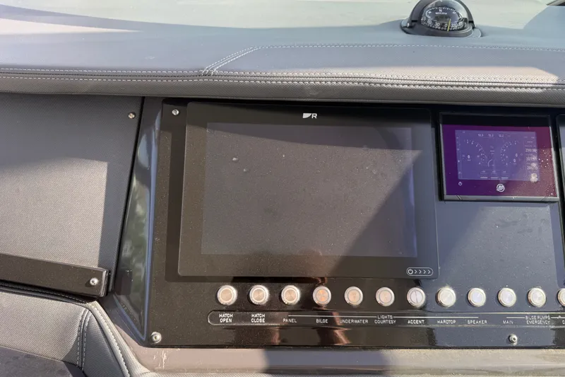 Slide: The Image of Dashboard of a 2021 Monterey 385SE Super Express boat with control panel and navigation instruments. - 49