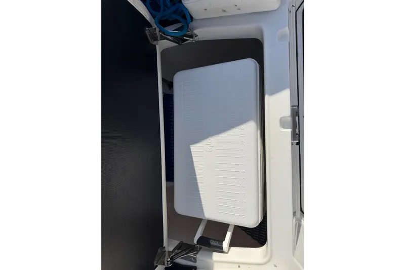 Slide: The Image of Storage compartment on 2021 Monterey 385SE Super Express boat, featuring a white cooler. - 44
