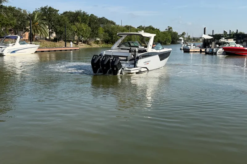 Slide: The Image of 2021 Monterey 385SE Super Express boat cruising in a serene marina setting. - 20