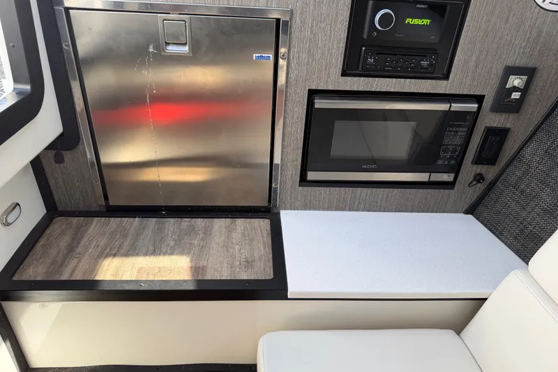 Slide: The Image of Interior of 2021 Monterey 385SE Super Express with microwave, fridge, and audio system. - 42