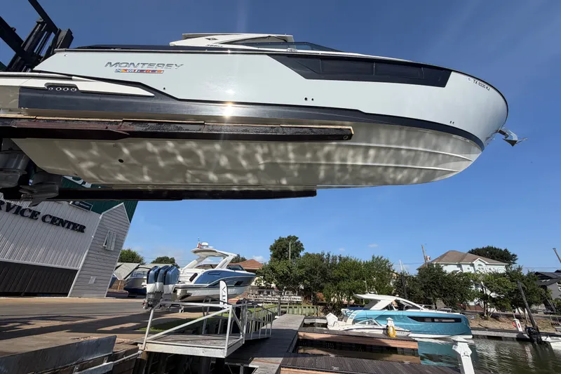 Slide: The Image of 2021 Monterey 385SE Super Express boat at marina service center, elevated for maintenance. - 64