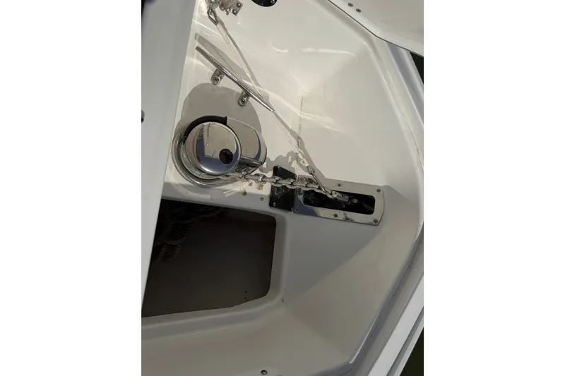 Slide: The Image of Anchor compartment of 2021 Monterey 385SE Super Express boat, featuring a winch and chain. - 48