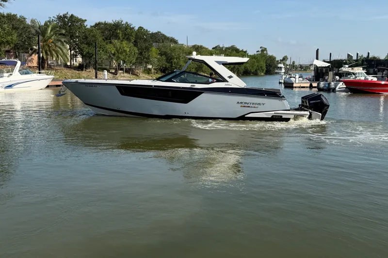 The Image of 2021 Monterey 385SE Super Express boat cruising on a calm river. - 12