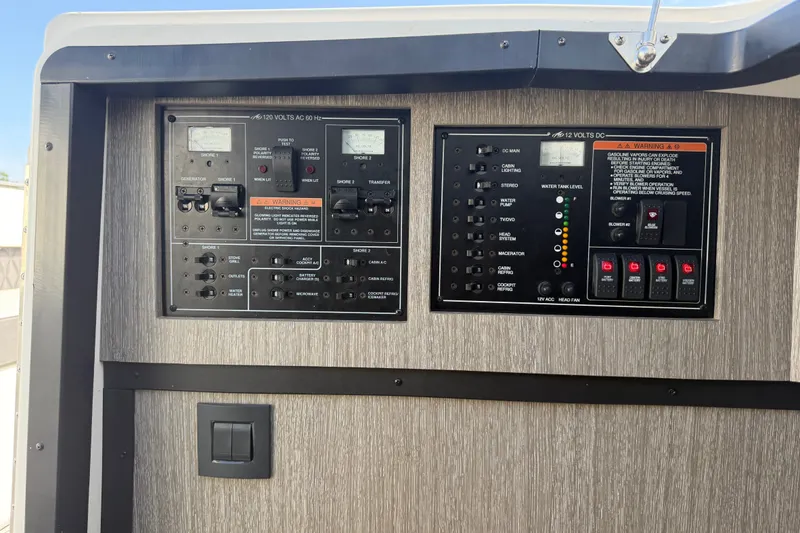 Slide: The Image of Control panel of a 2021 Monterey 385SE Super Express boat, featuring AC and DC switches. - 41