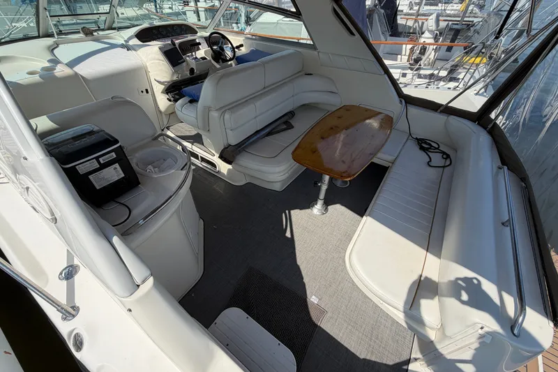Slide: The Image of Interior of a 1996 Sea Ray Sundancer 330 boat with seating and a wooden table. - 22
