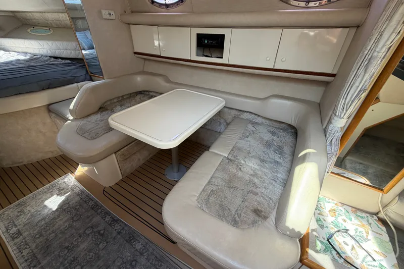 Slide: The Image of 1996 Sea Ray Sundancer 330 interior with cozy seating and dining area. - 29