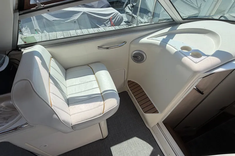 Slide: The Image of Interior of a 1996 Sea Ray Sundancer 330 boat with white seating and cup holders. - 17