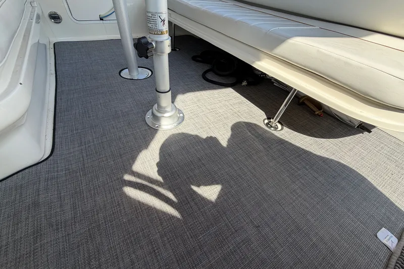Slide: The Image of 1996 Sea Ray Sundancer 330 interior with gray carpet and white seating. - 24