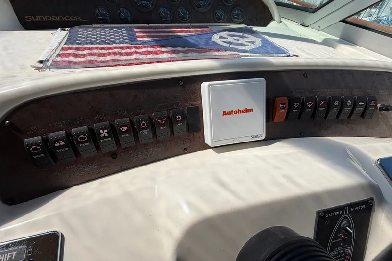 Slide: The Image of 1996 Sea Ray Sundancer 330 dashboard with control panel and American flag detail. - 14