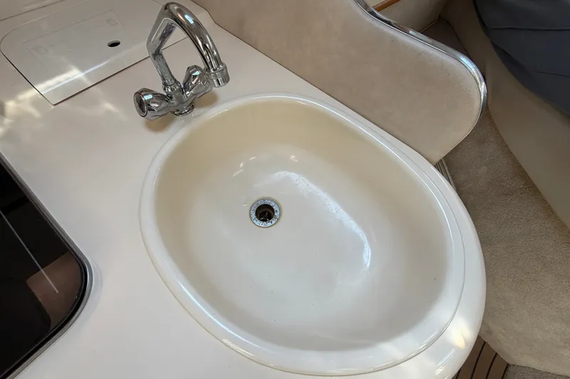 Slide: The Image of A cream-colored sink with a shiny faucet in a boat interior. - 33