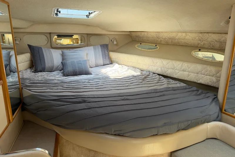 Slide: The Image of Luxurious cabin interior of 1996 Sea Ray Sundancer 330 with cozy bedding and porthole windows. - 36