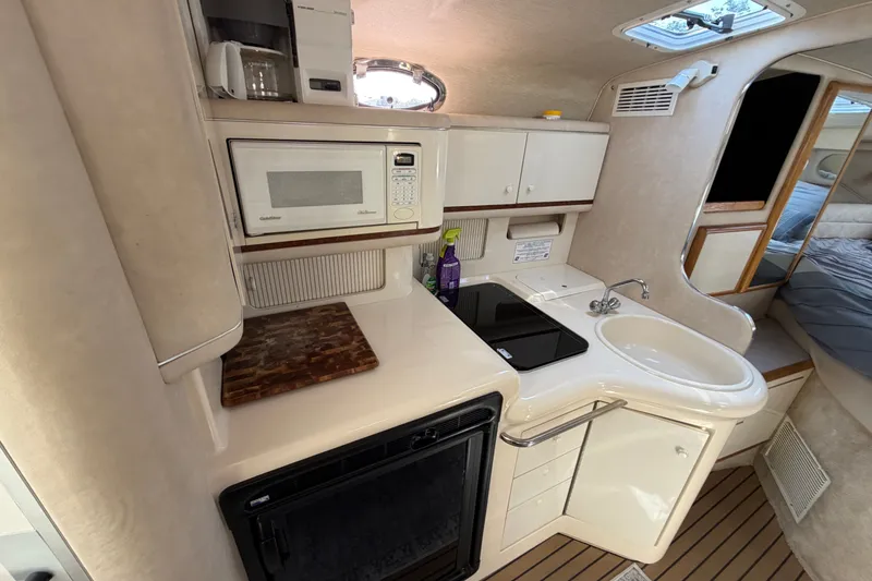 Slide: The Image of Interior of a 1996 Sea Ray Sundancer 330 yacht kitchen with microwave, sink, and stove. - 30