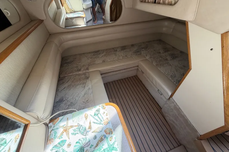 Slide: The Image of Interior cabin of 1996 Sea Ray Sundancer 330 with beige seating and wood accents. - 43