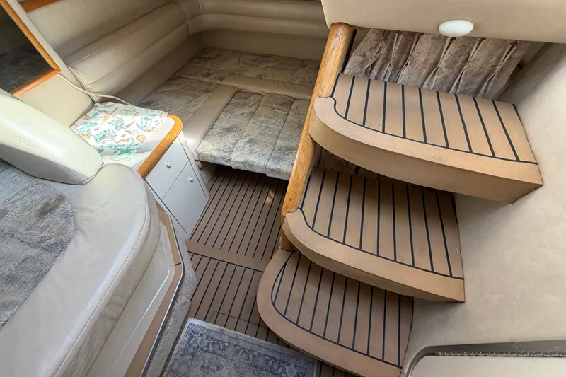 Slide: The Image of Interior of 1996 Sea Ray Sundancer 330 with wooden steps and cozy seating area. - 44
