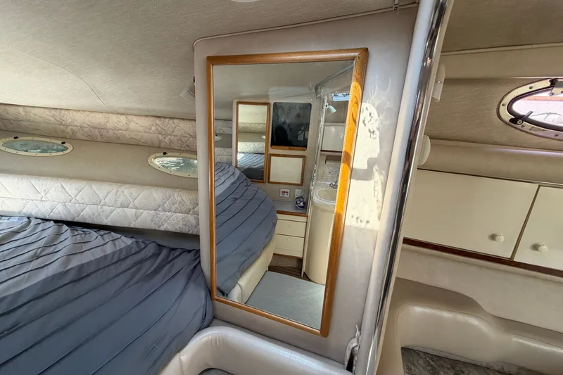 Slide: The Image of Interior of a 1996 Sea Ray Sundancer 330 yacht, featuring a cozy cabin with a mirror. - 40