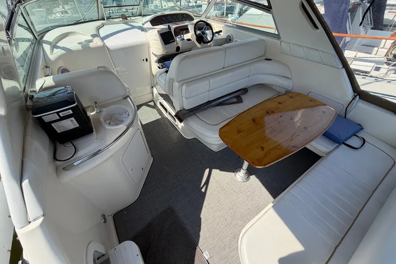 Slide: The Image of Interior of a 1996 Sea Ray Sundancer 330 yacht with white seating and wooden table. - 20