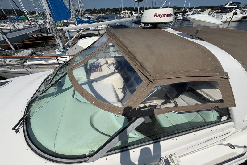 Slide: The Image of 1996 Sea Ray Sundancer 330 yacht with tan canopy, docked at marina. - 9