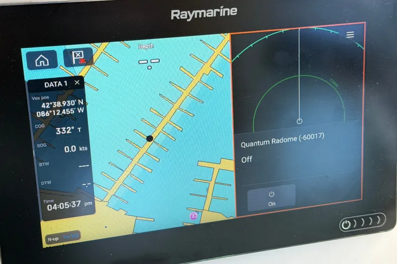 Slide: The Image of Raymarine navigation display on 1996 Sea Ray Sundancer 330, showing coordinates and radar status. - 52